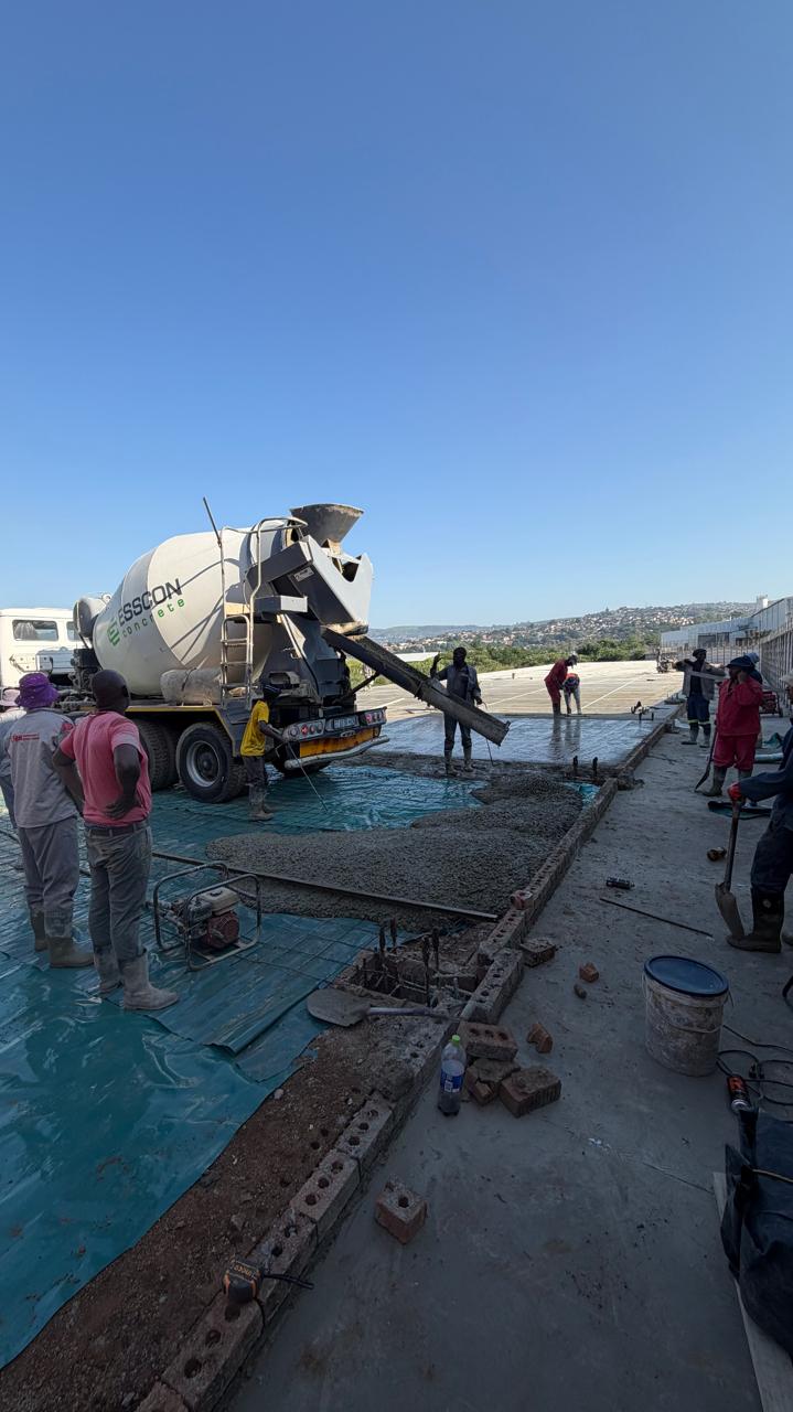Esscon Concrete mixer truck pouring a slab with the crew on site