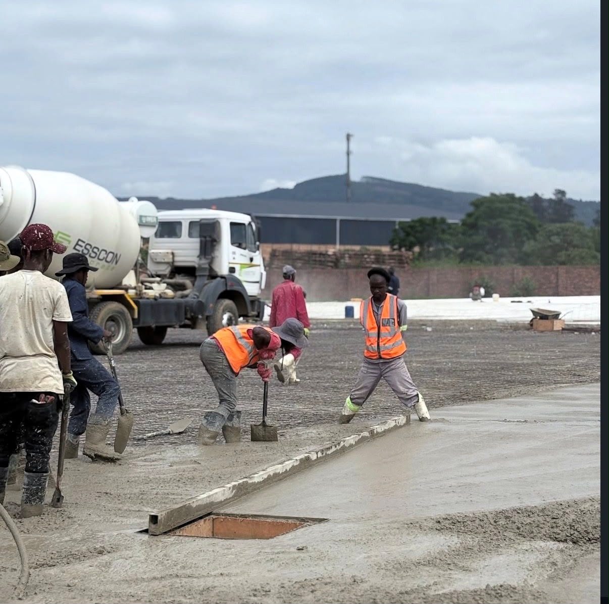 Esscon team screeding a fresh ready-mix concrete slab